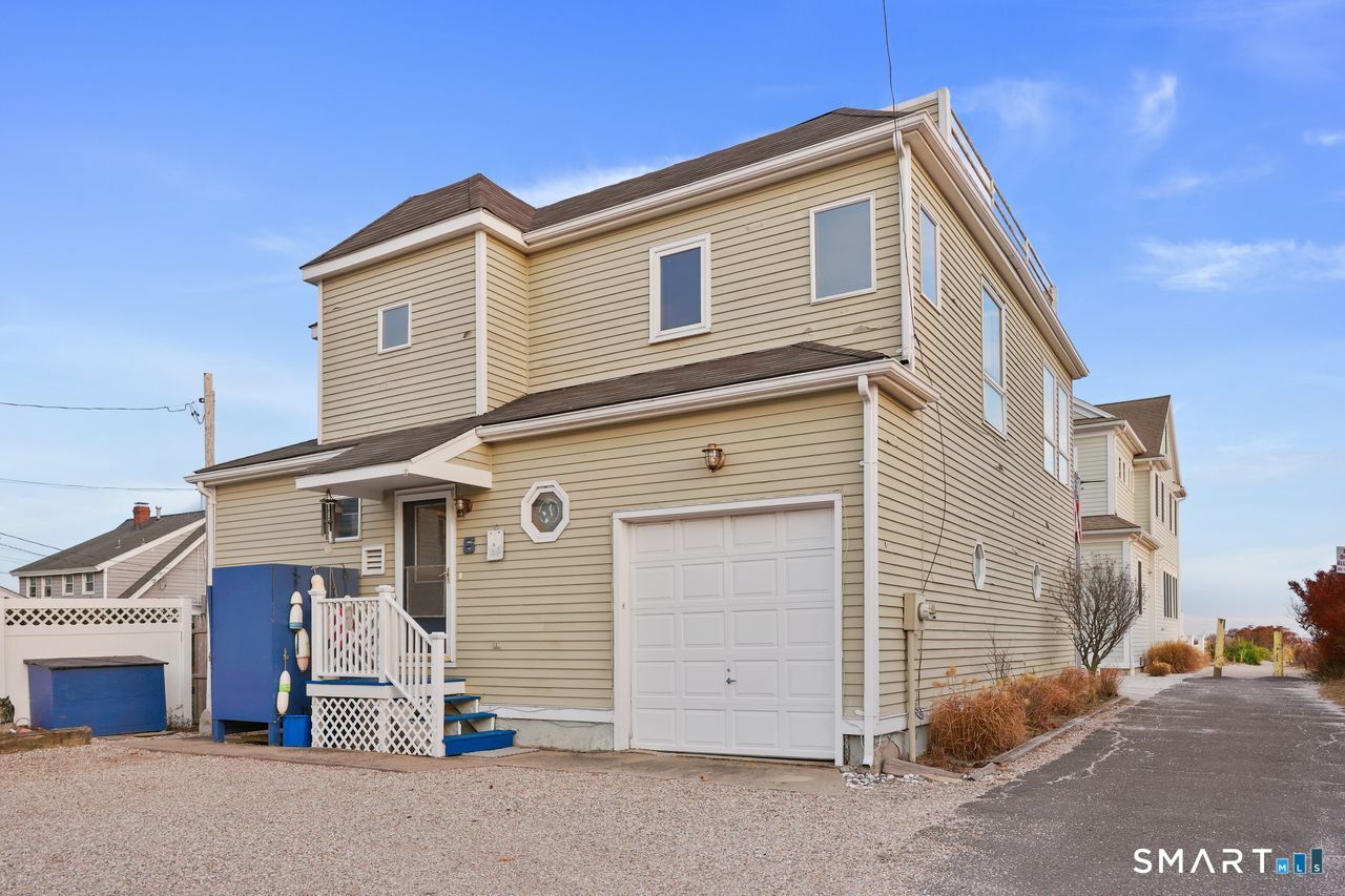 6 Lighthouse Point Fairfield, CT 06824 - Photo 3 of 40 a front view of a house with a garage
