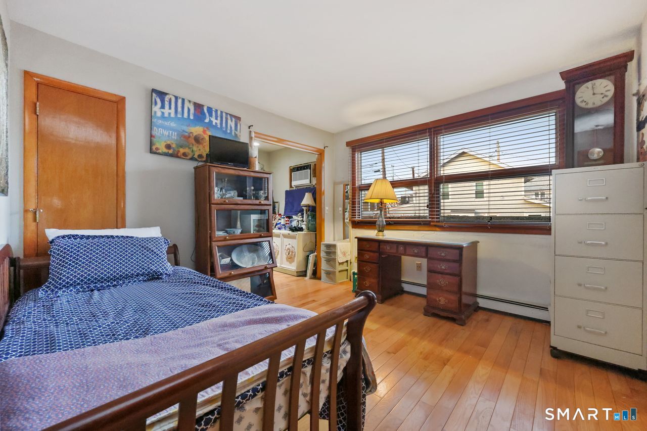 6 Lighthouse Point Fairfield, CT 06824 - Photo 32 of 40 a bedroom with furniture and a window