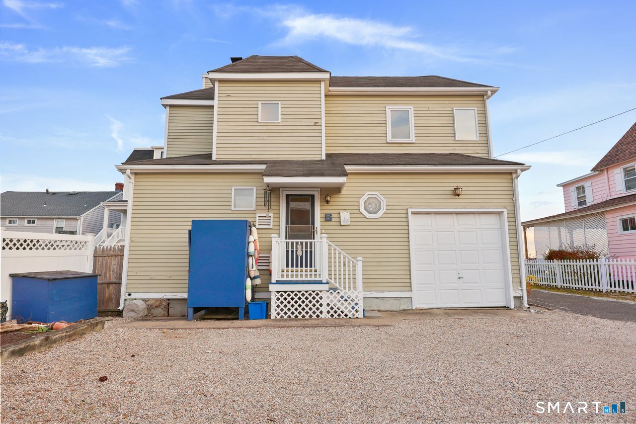 6 Lighthouse Point Fairfield, CT 06824 - Photo 4 of 40 a front view of a house with a garage