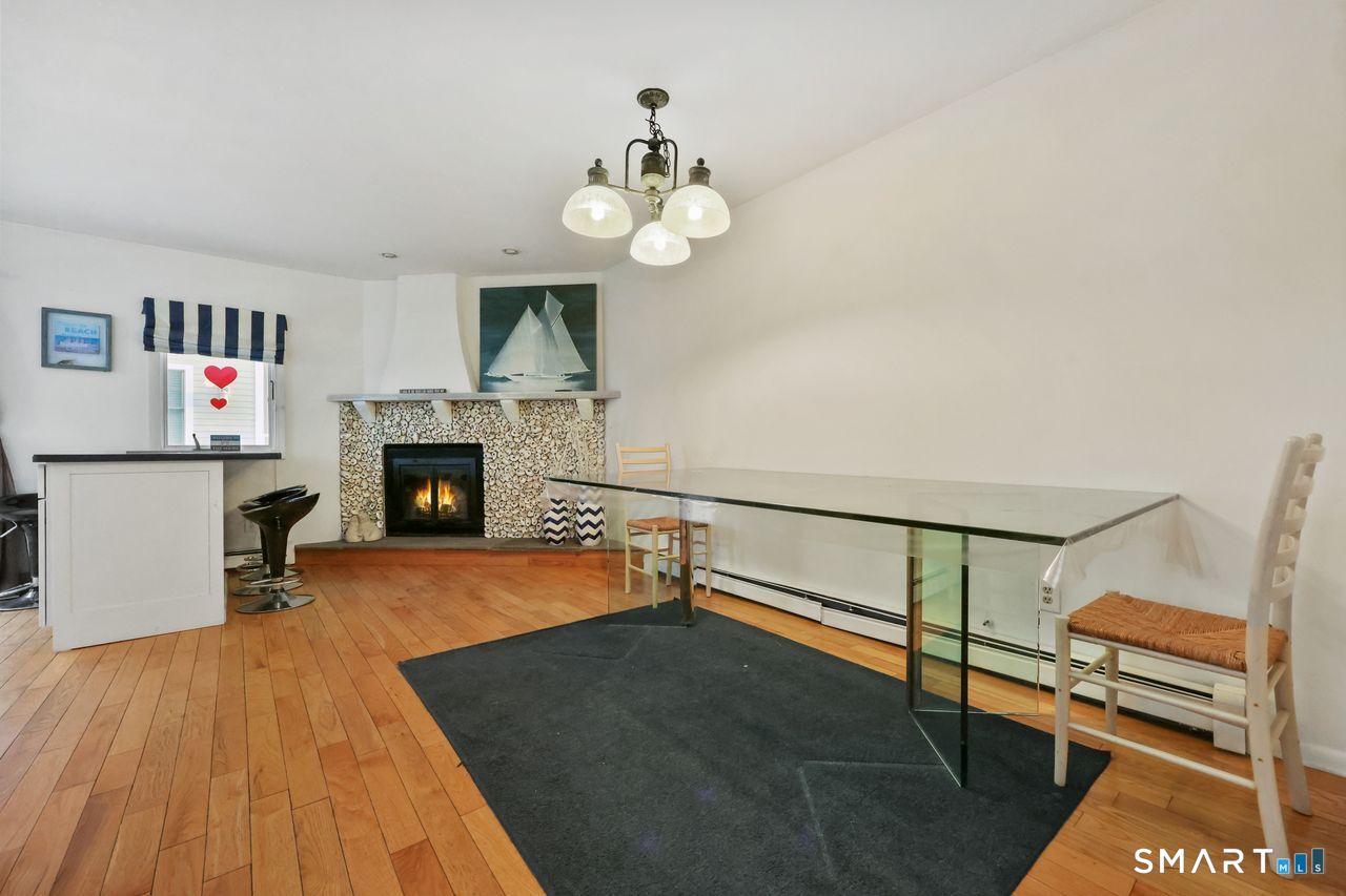 6 Lighthouse Point Fairfield, CT 06824 - Photo 9 of 40 a living room with furniture and a fireplace