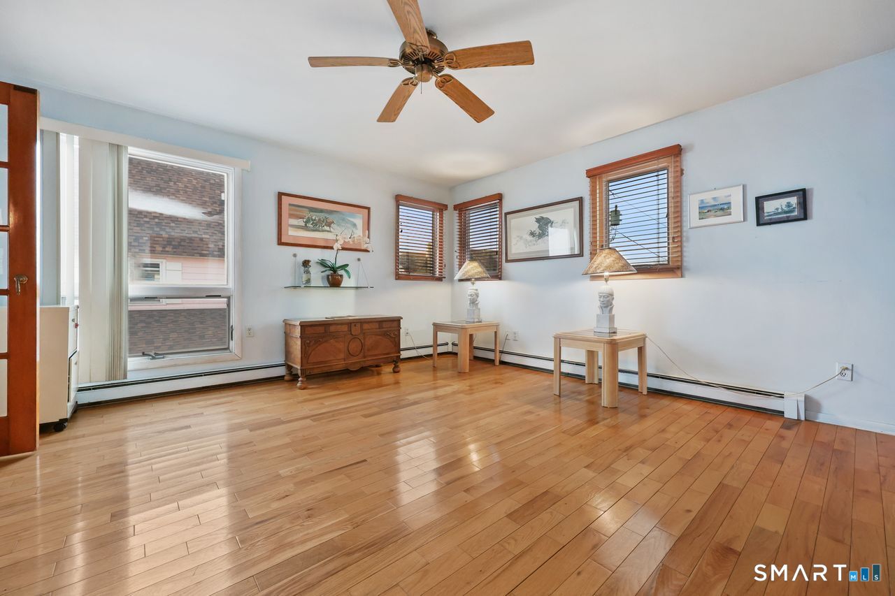 6 Lighthouse Point Fairfield, CT 06824 - Photo 10 of 40 a room with furniture and a wooden floor