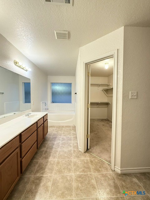2104 Prestige Loop Killeen, TX 76549 - Photo 14 of 29 a large bathroom with a glass shower door a sink and a bathtub