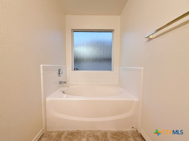 2104 Prestige Loop Killeen, TX 76549 - Photo 17 of 29 a white bath tub sitting next to a white sink and vanity