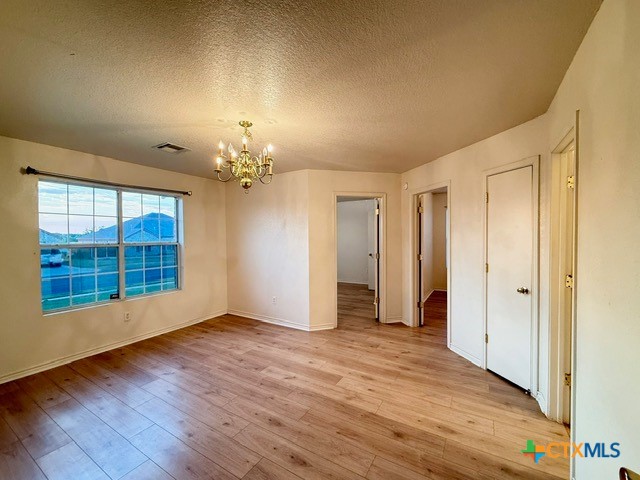 2104 Prestige Loop Killeen, TX 76549 - Photo 21 of 29 a view of an empty room with a window and wooden floor