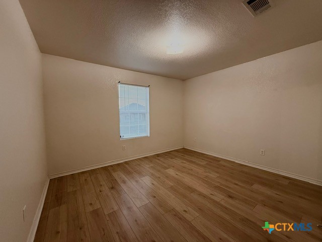 2104 Prestige Loop Killeen, TX 76549 - Photo 23 of 29 an empty room with wooden floor and windows