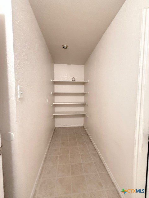 2104 Prestige Loop Killeen, TX 76549 - Photo 26 of 29 a view of walk in closet with empty racks