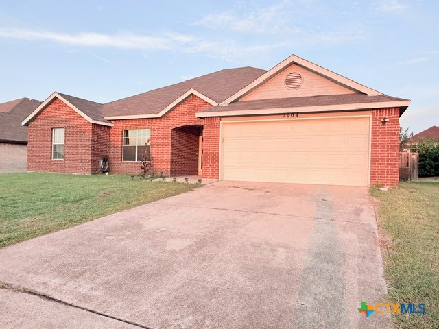 2104 Prestige Loop Killeen, TX 76549 - Photo 3 of 29 a front view of a house with a yard and garage