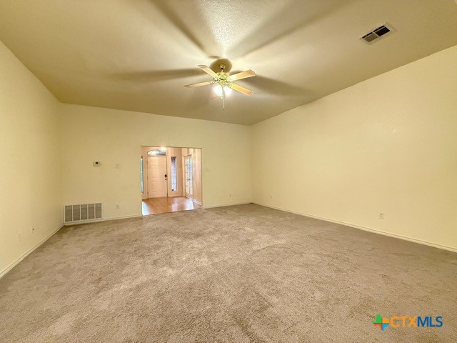 2104 Prestige Loop Killeen, TX 76549 - Photo 5 of 29 an empty room with a chandelier fan and windows