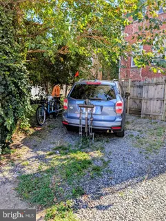 a backyard of a house with barbeque oven table and chairs