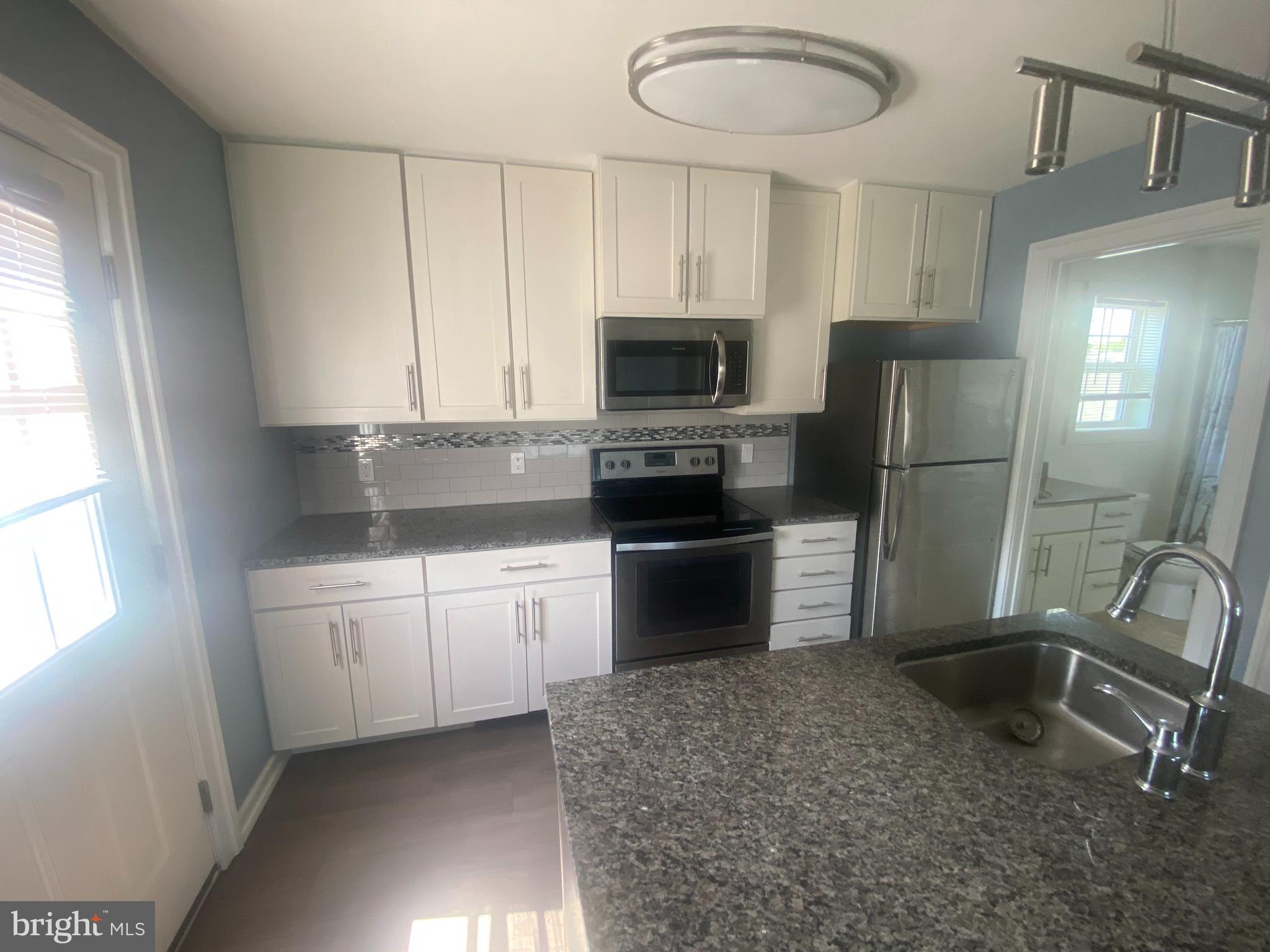 124 Mortimer Street Dunmore, PA 18512 - Photo 3 of 10 a kitchen with a refrigerator and a sink