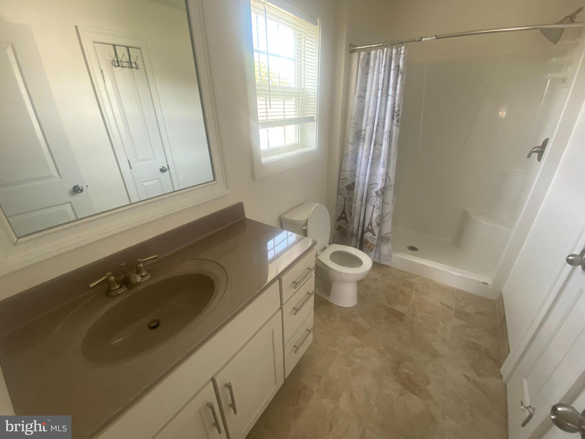 124 Mortimer Street Dunmore, PA 18512 - Photo 5 of 10 a bathroom with a sink a toilet and shower