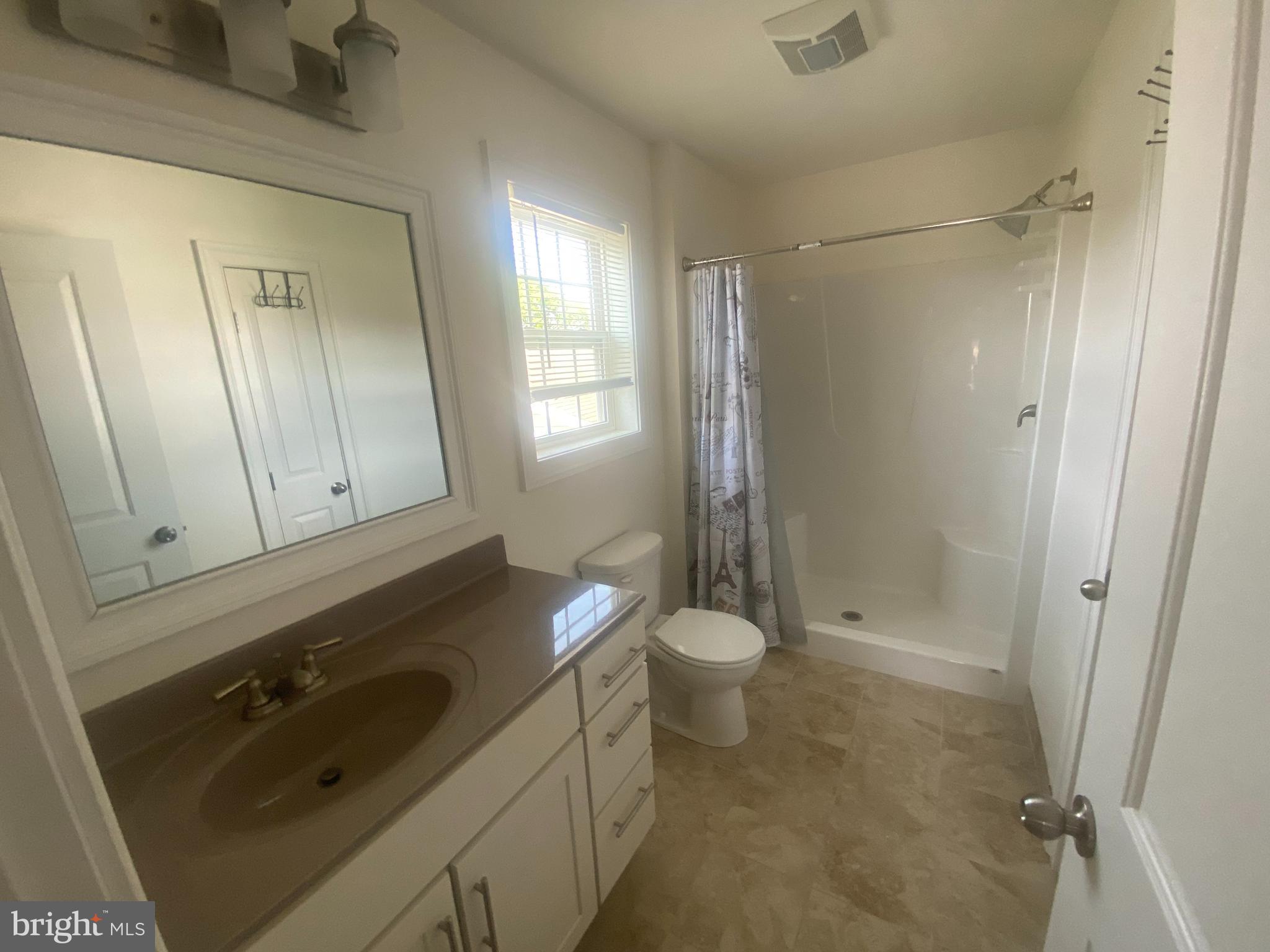 124 Mortimer Street Dunmore, PA 18512 - Photo 10 of 10 a bathroom with a sink a toilet and shower