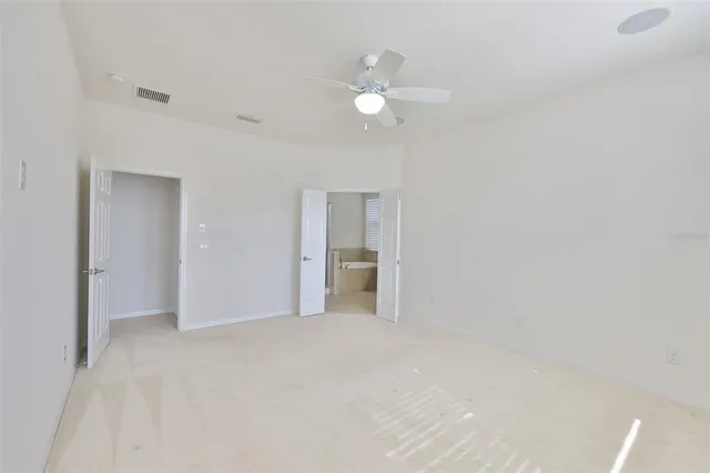 a bathroom with a granite countertop sink a toilet and bathtub