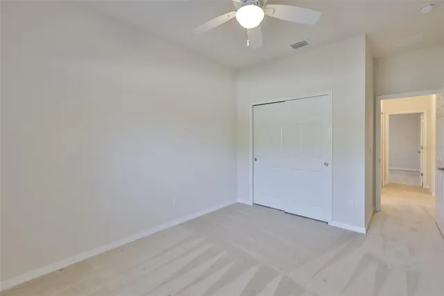 a bathroom with a granite countertop sink a toilet and a mirror