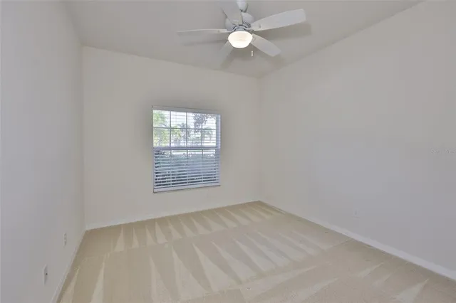 an empty room with fan and entrance