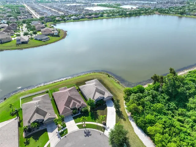 an aerial view of a house with a lake view