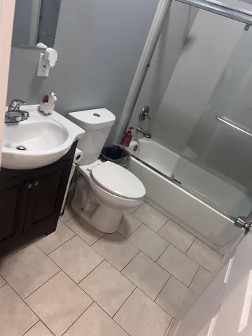 a white toilet sitting next to a bathroom sink