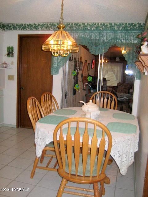 1880 Pleasant Hill Road Selah, WA 98942 - Photo 6 of 20 a view of a dining room with furniture and a chandelier
