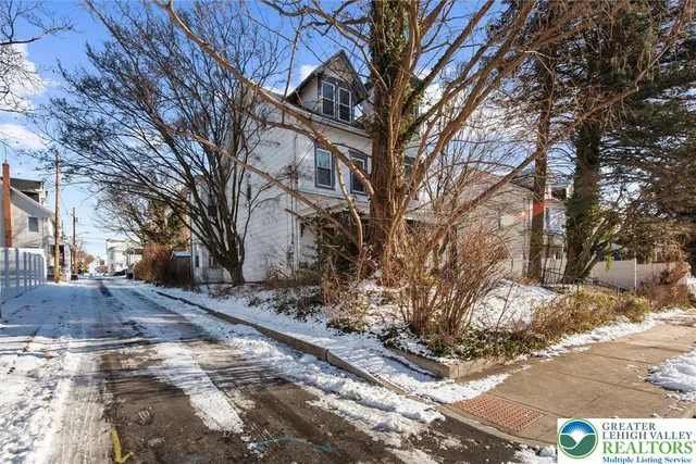a view of a yard covered with snow