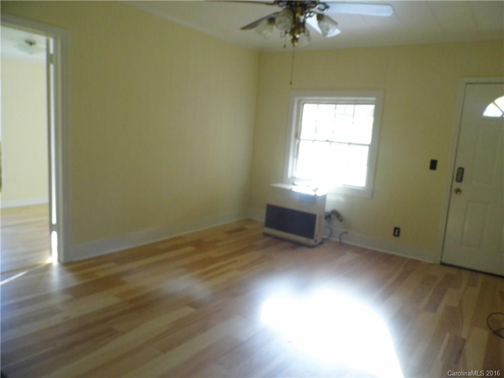 8376 Smith Road Stanfield, NC 28163 - Photo 11 of 15 an empty room with wooden floor and windows