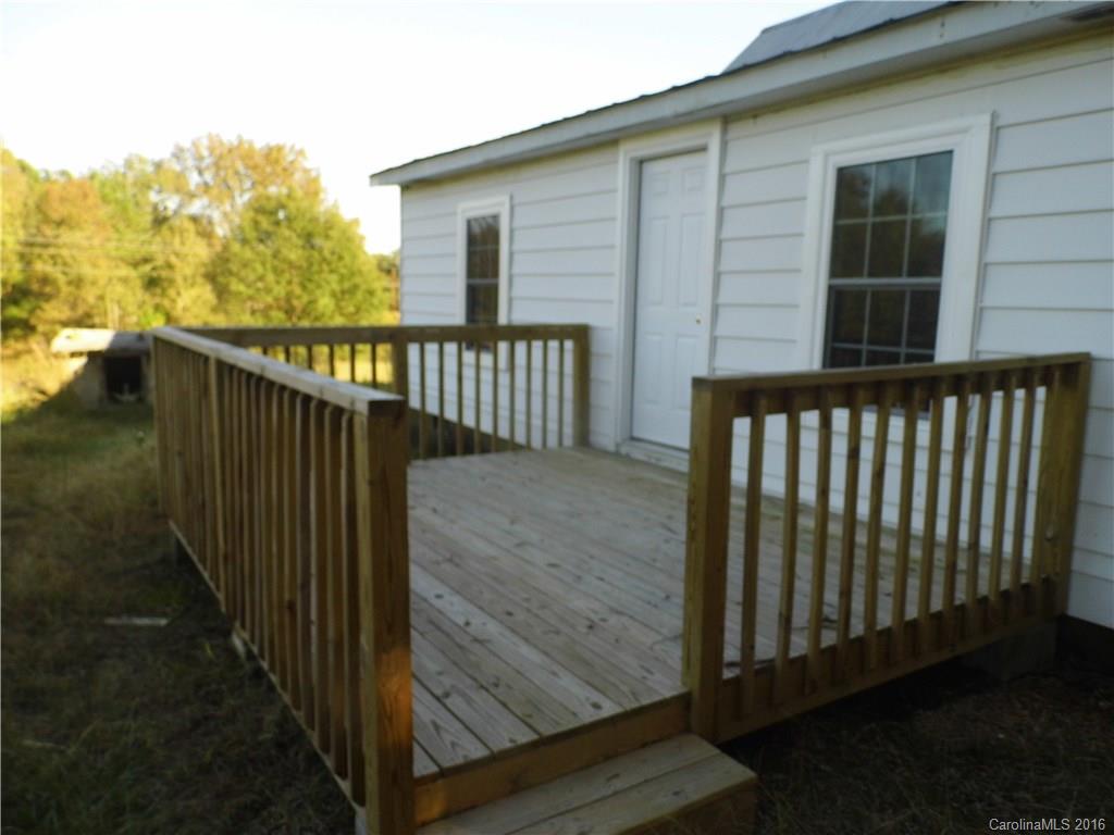 8376 Smith Road Stanfield, NC 28163 - Photo 3 of 15 a view of a balcony with wooden floor and fence
