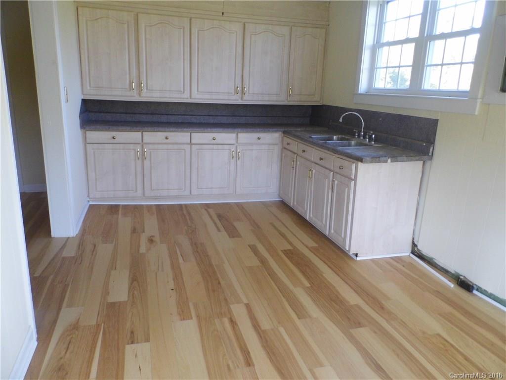 8376 Smith Road Stanfield, NC 28163 - Photo 8 of 15 a kitchen with a sink a window and cabinets