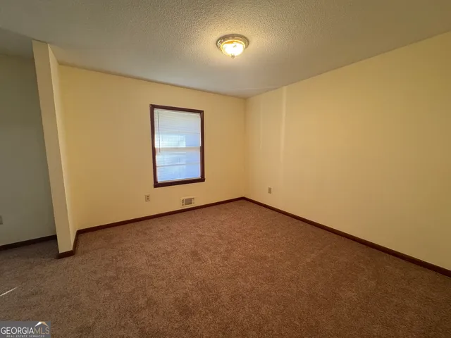 an empty room with a empty space and windows