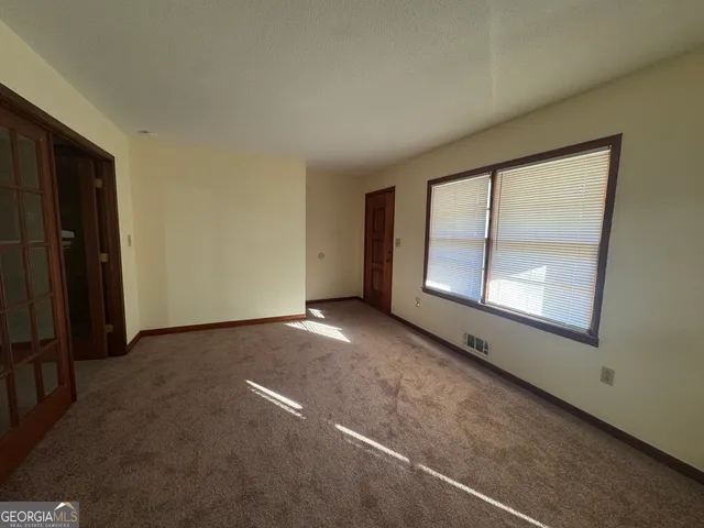 an empty room with a empty space and windows