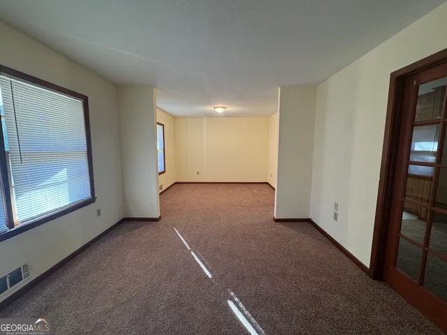 a view of an empty room with a window