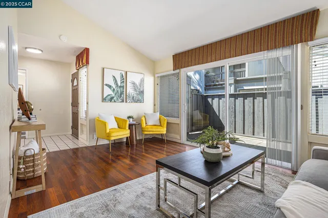 a living room with furniture a rug and a large window