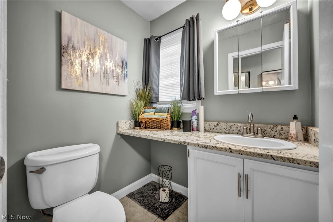 13800 Milo Road Garfield Heights, OH 44125 - Photo 18 of 39 Bathroom with vanity and light tile patterned flooring