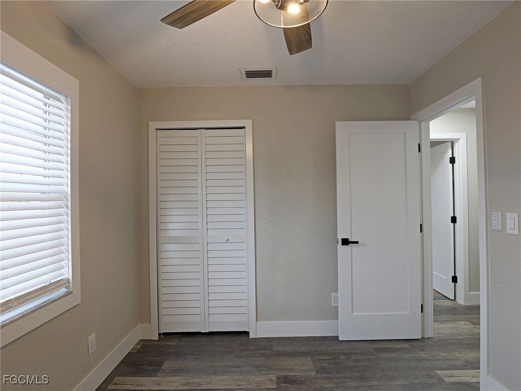 14181 Old Olga Road Fort Myers, FL 33905 - Photo 12 of 13 a view of an empty room with a window and wooden floor