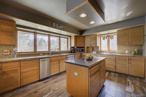 a kitchen with stainless steel appliances granite countertop a sink and cabinets