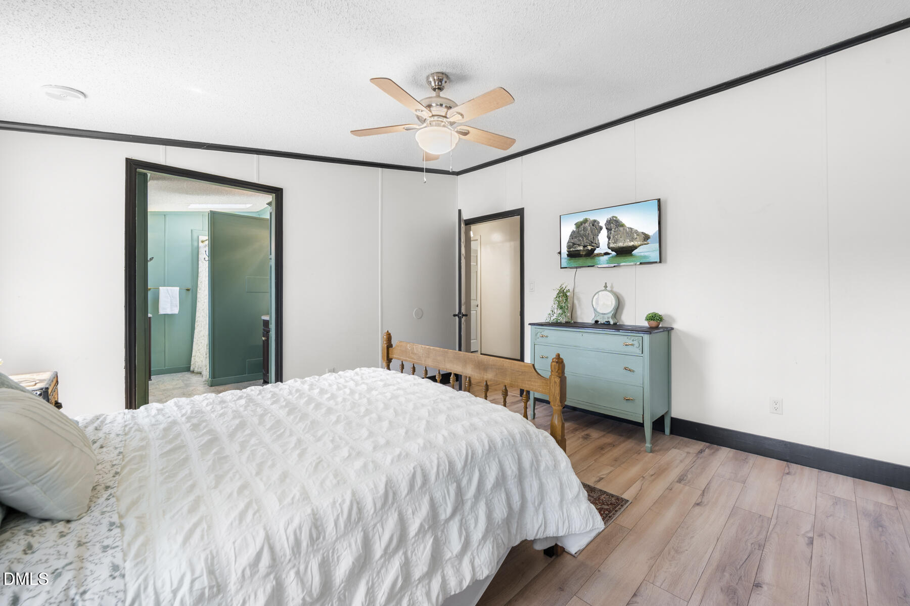 492 Little Mill Road Henderson, NC 27537 - Photo 21 of 39 a bedroom with a large bed a chandelier and a window