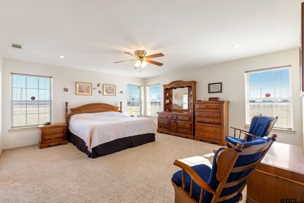 a kitchen with a refrigerator a oven a counter top space and a dining table