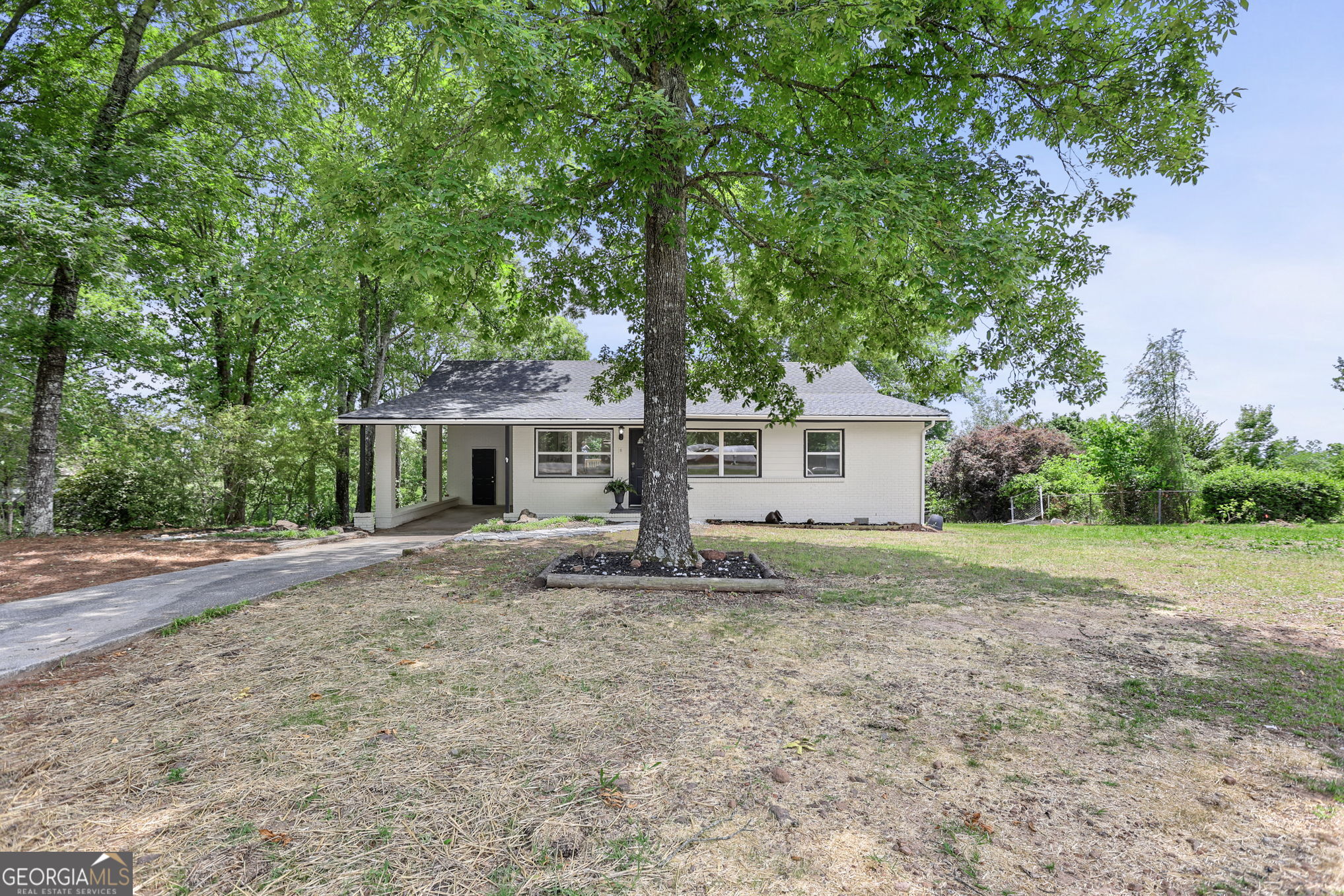 7060 Scenic Heights Road Manchester, GA 31816 - Photo 4 of 52 a front view of a house with a yard and garage