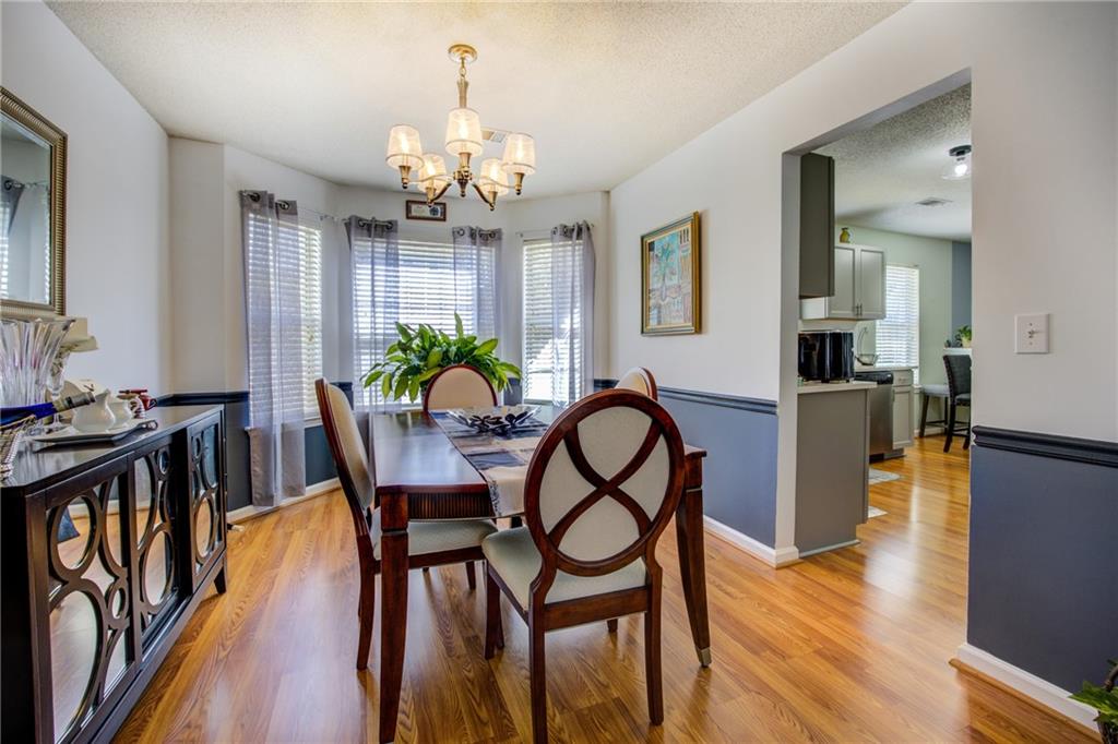 4885 Hidden Creek Place Decatur, GA 30035 - Photo 11 of 52 a view of a dining room with furniture wooden floor and chandelier