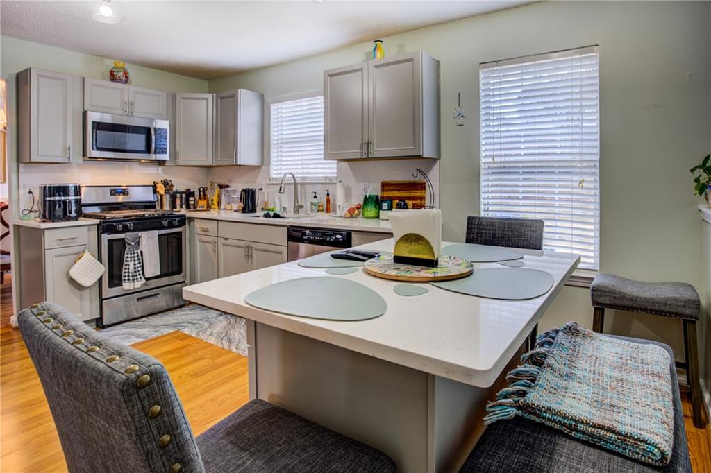 4885 Hidden Creek Place Decatur, GA 30035 - Photo 17 of 52 a kitchen with stainless steel appliances granite countertop a sink a stove top oven a counter space and cabinets
