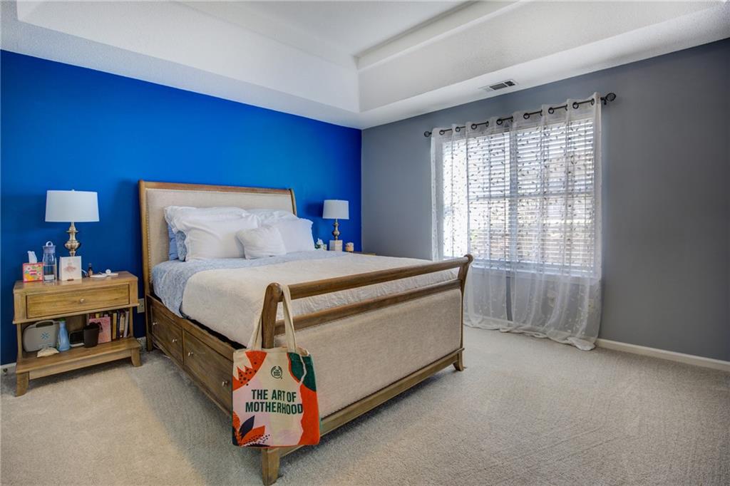 4885 Hidden Creek Place Decatur, GA 30035 - Photo 24 of 52 a bed sitting in a bedroom next to a window