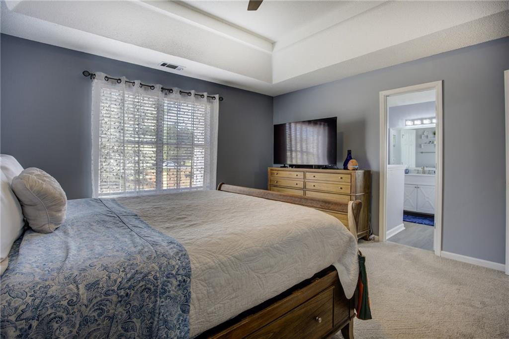 4885 Hidden Creek Place Decatur, GA 30035 - Photo 25 of 52 a bedroom with a bed and a television in it