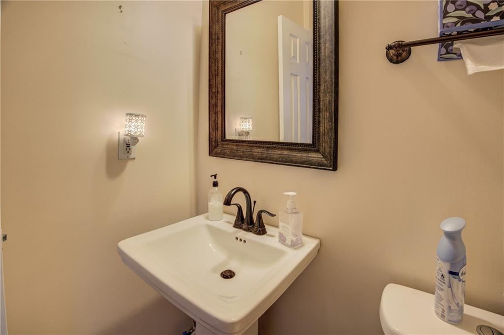 4885 Hidden Creek Place Decatur, GA 30035 - Photo 36 of 52 a bathroom with a sink a toilet and mirror