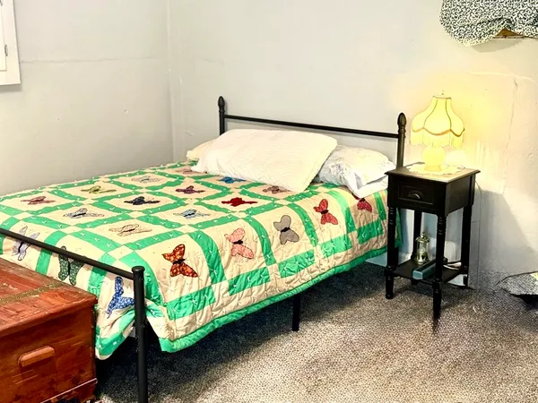 a bedroom with a bed a table and chair