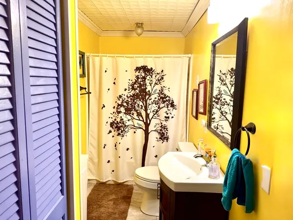 a bathroom with a sink toilet and shower