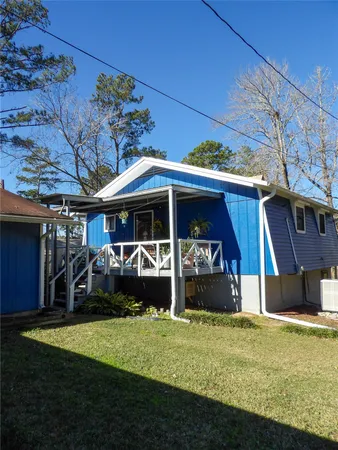 a view of a house with a yard and sitting area