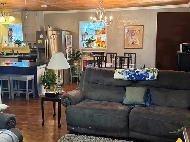 a kitchen with stainless steel appliances granite countertop a stove a sink dishwasher and cabinets with wooden floor