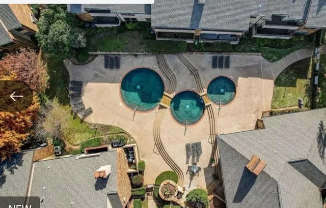 an aerial view of a house with swimming pool and outdoor space
