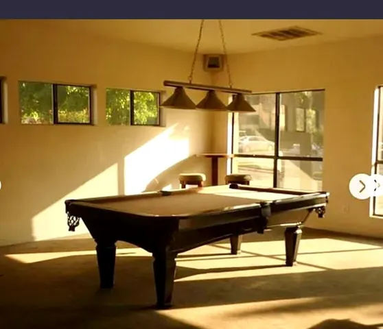 a view of a swimming pool with a table and chairs