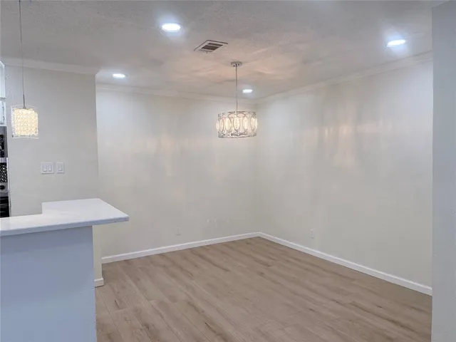 a view of a room with wooden floor and window