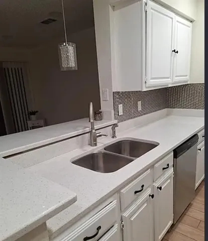 a kitchen with a sink and cabinets