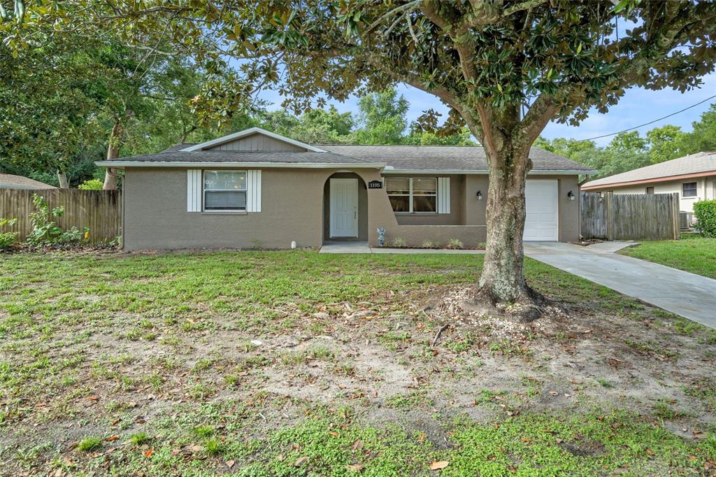 1195 Larkin Road Spring Hill, FL 34608 - Photo 1 of 1 a house with trees in the background